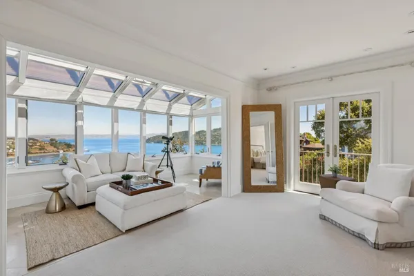 a bedroom with a large bed and a chandelier