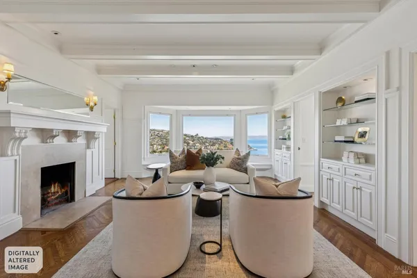 a living room with furniture a rug and a chandelier