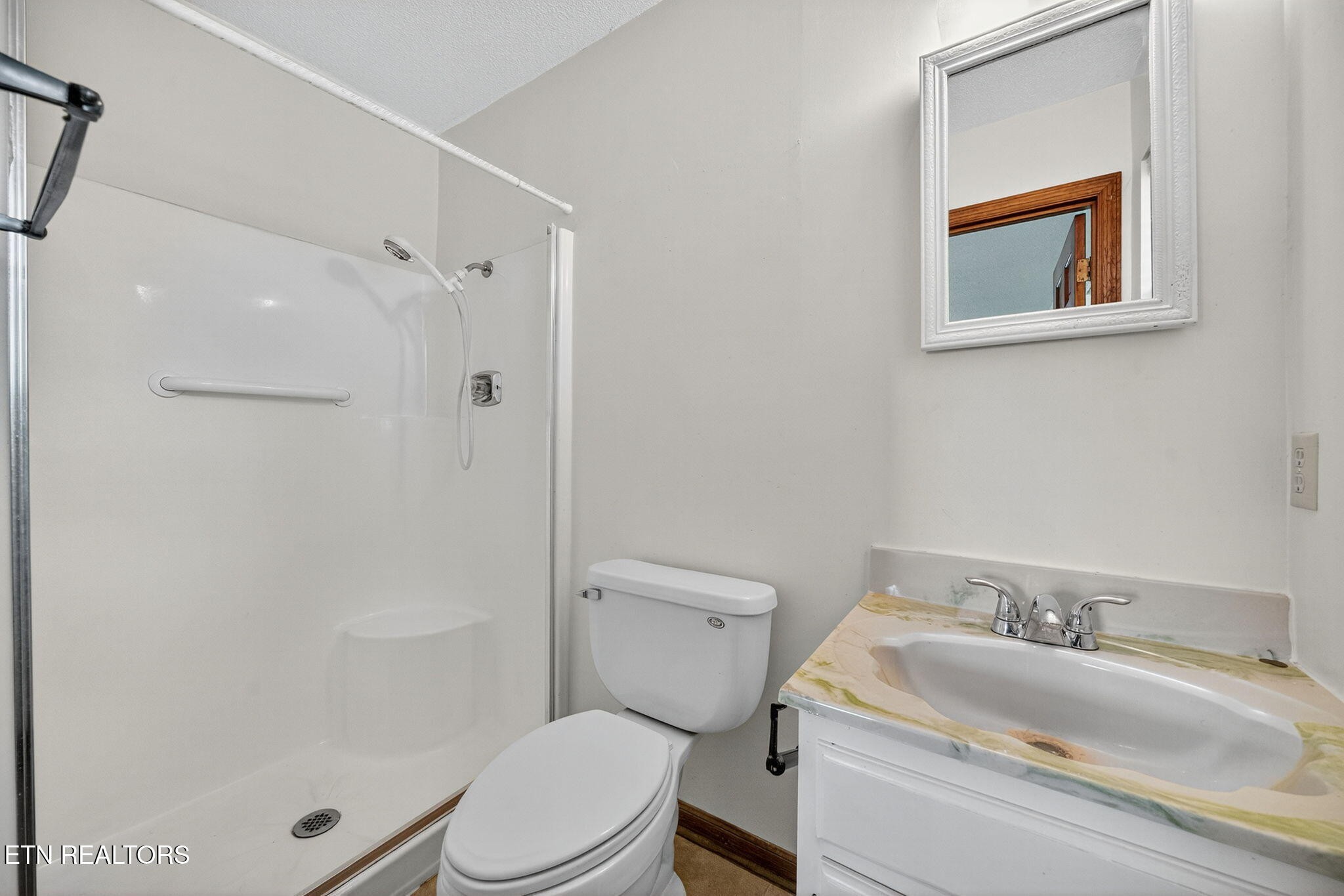 330 Hutsell Drive Decatur, TN 37322 - Photo 14 of 35 a bathroom with a granite countertop toilet a sink and a mirror