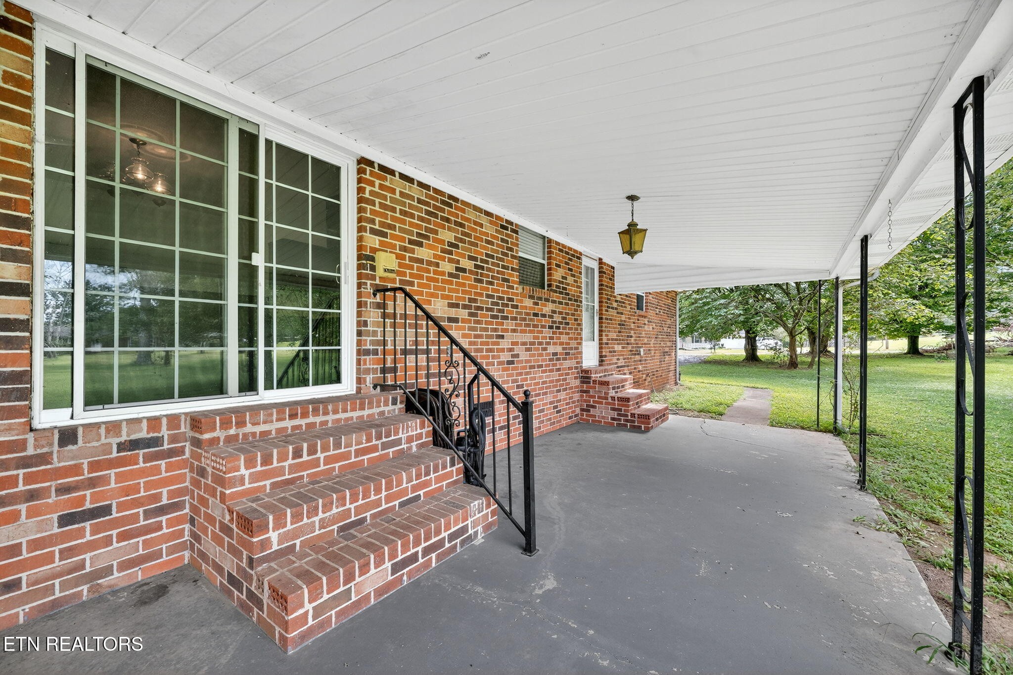 330 Hutsell Drive Decatur, TN 37322 - Photo 25 of 35 a view of a porch with furniture and floor to ceiling window