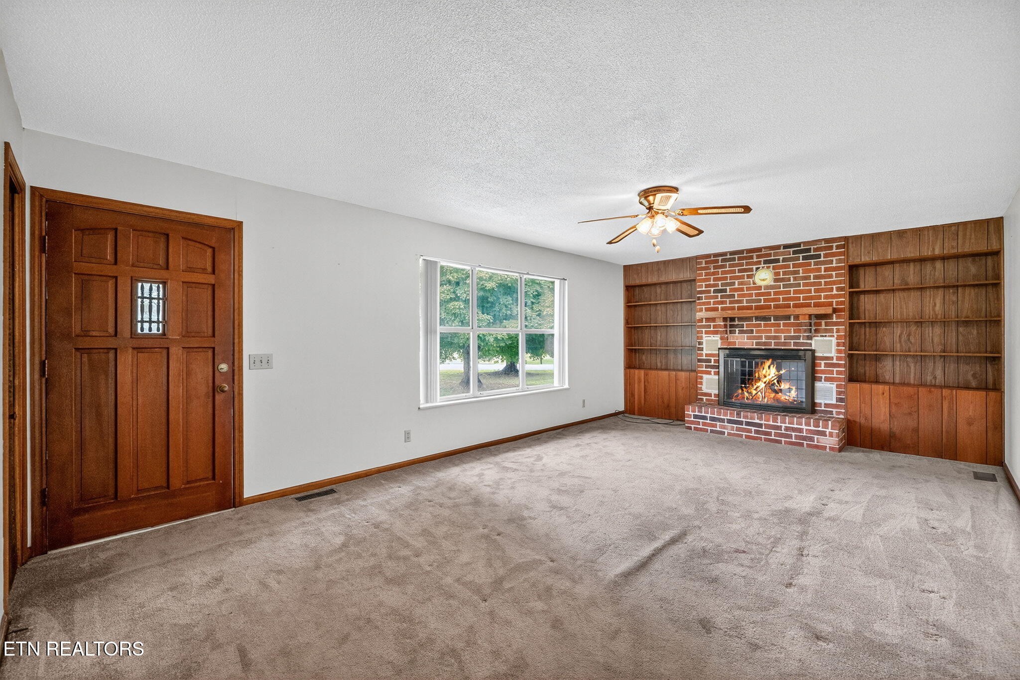 330 Hutsell Drive Decatur, TN 37322 - Photo 4 of 35 a view of an empty room with a fireplace and a window