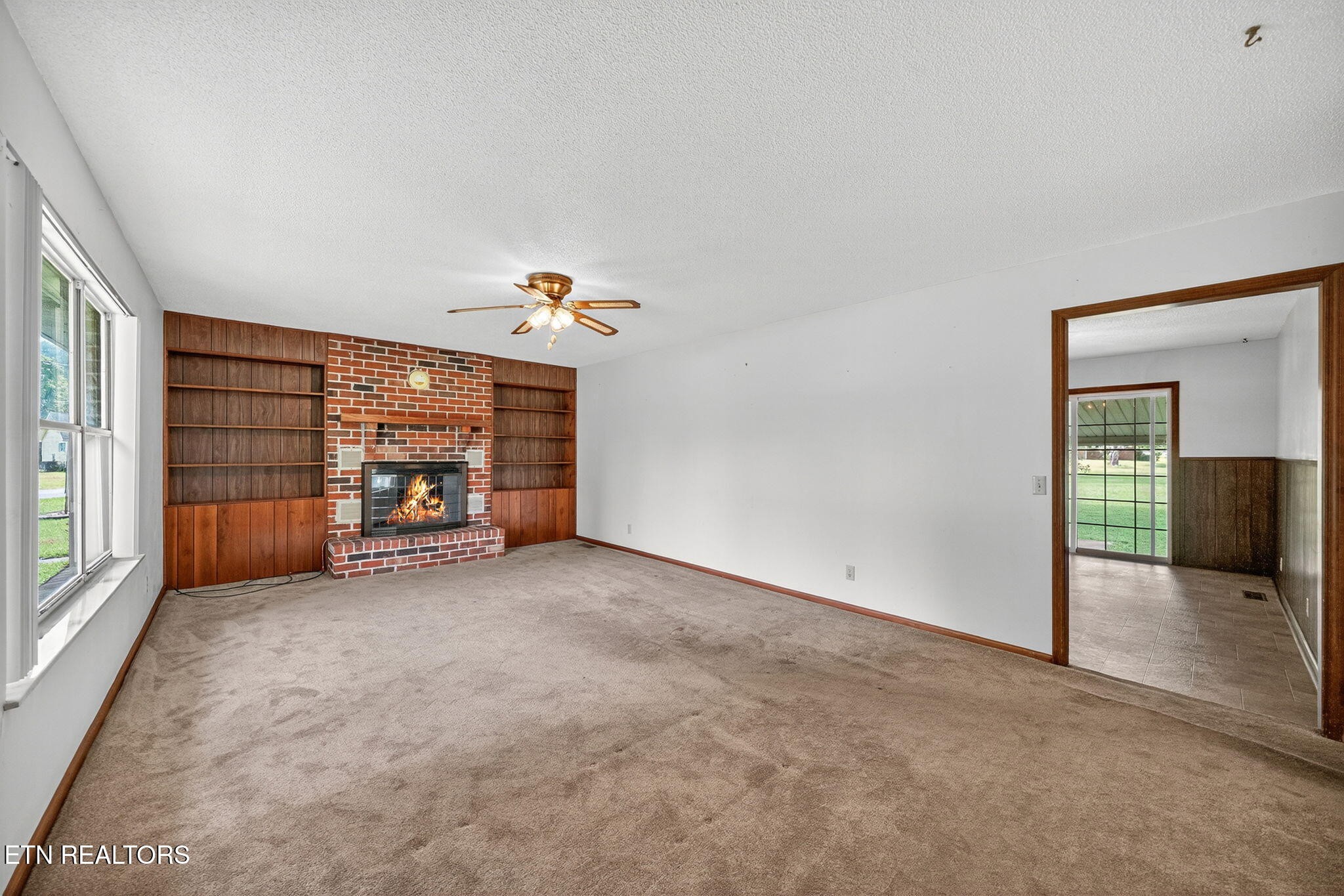 330 Hutsell Drive Decatur, TN 37322 - Photo 6 of 35 an empty room with fireplace and window
