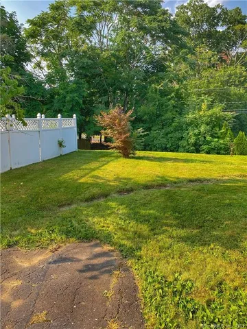 a backyard of a house with lots of green space and fountain