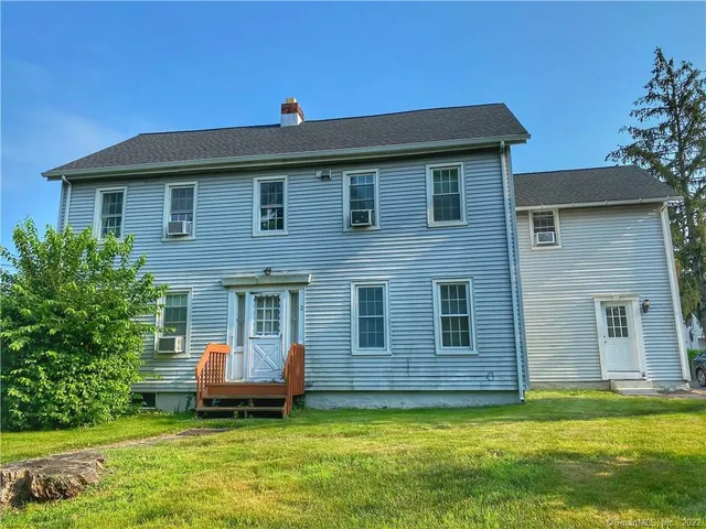 a view of a house with a backyard