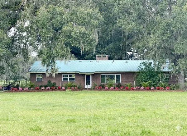 a front view of house with yard and green space
