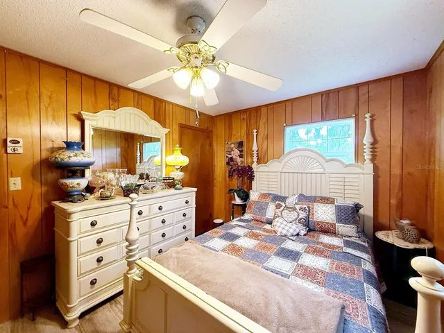 a room with a chandelier and dresser