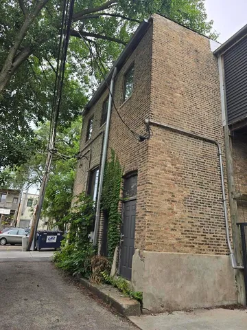 a brick house with a tree in front of it
