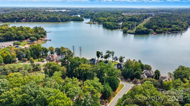 an aerial view of a swimming pool with outdoor seating