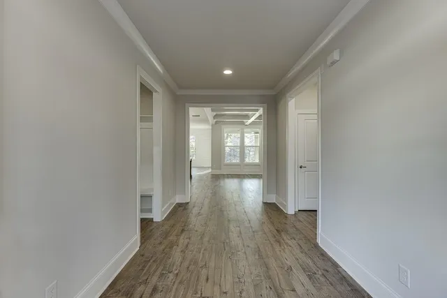 a view of hallway with wooden floor