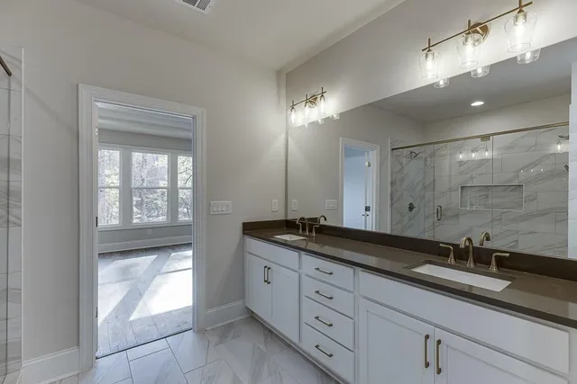a bathroom with double sink and a mirror