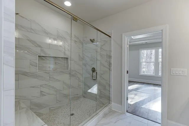 a bathroom with a glass shower door
