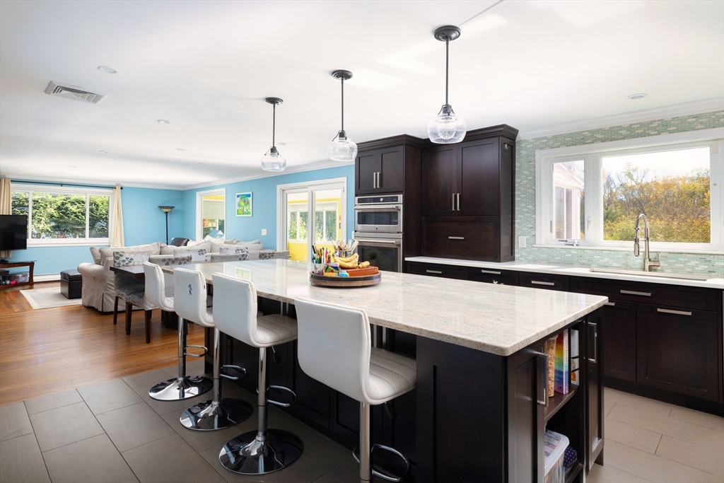 45 Brandeis Road Newton, MA 02459 - Photo 5 of 12 a kitchen with a dining table chairs sink and granite counter tops