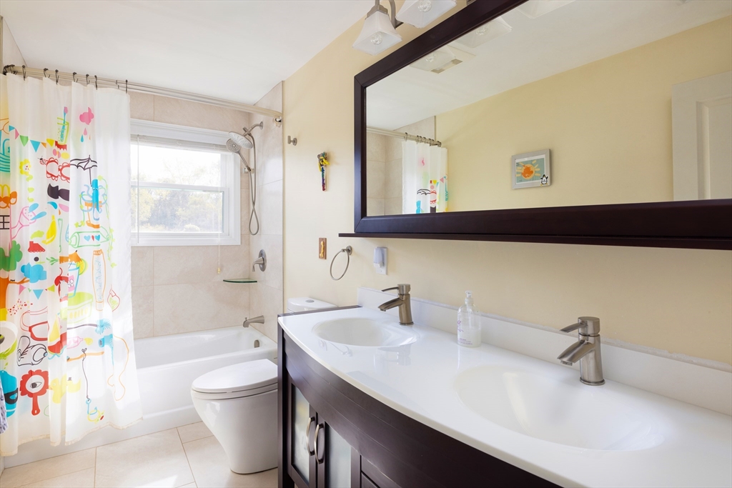 45 Brandeis Road Newton, MA 02459 - Photo 10 of 12 a bathroom with a sink a toilet and shower curtain
