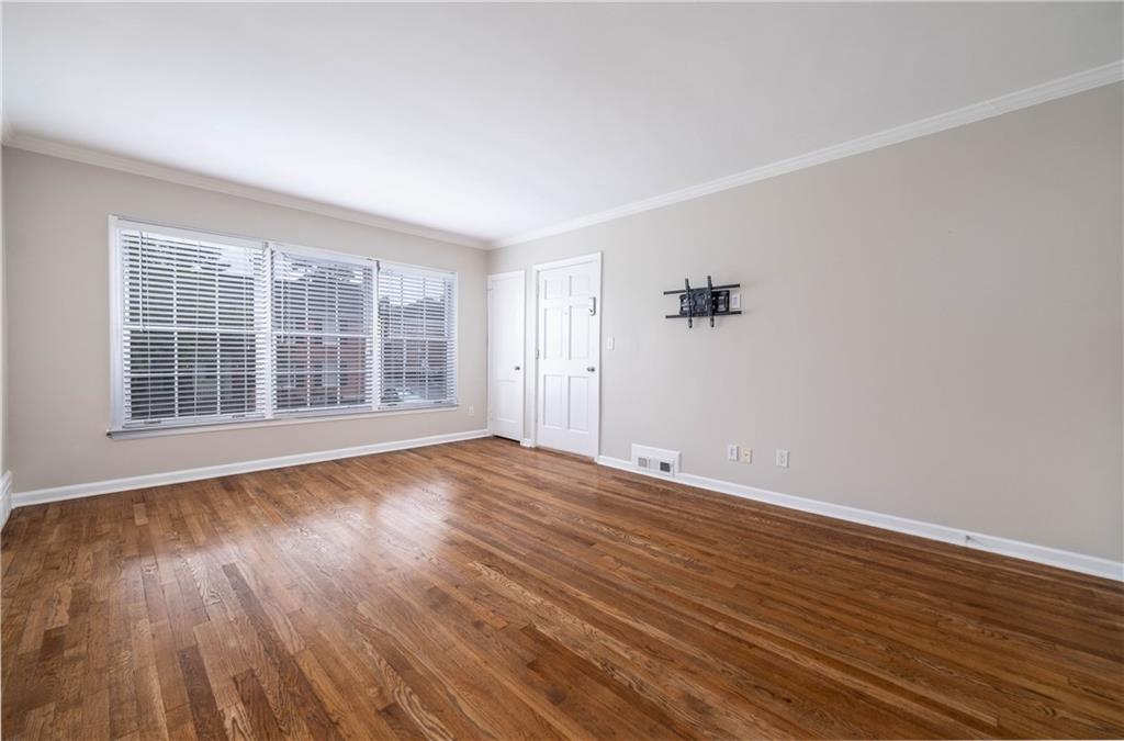 3669 Peachtree Road Northeast, Unit 3D Atlanta, GA 30319 - Photo 1 of 1 wooden floor in an empty room with a window
