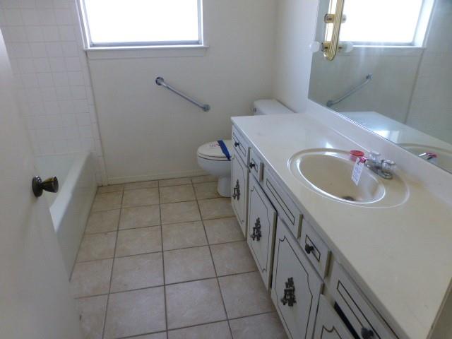 4612 Ranch View Road Fort Worth, TX 76109 - Photo 14 of 17 a bathroom with a sink a toilet and a mirror