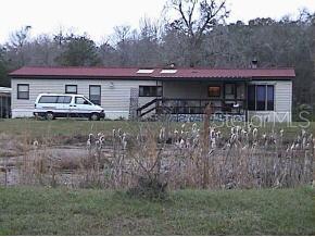 750 Southwest 41lp/little Springs Rd Lake Lake Butler, FL 32054 - Photo 1 of 1 a front view of house with yard and trees in the background