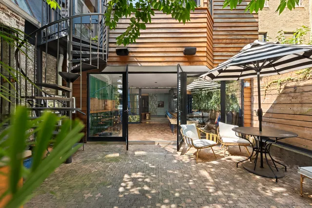 a view of a backyard with sitting area