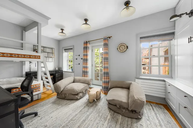 a bedroom with furniture and a flat screen tv