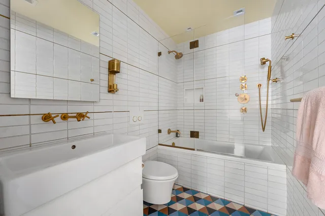 a bedroom with a bed and a table with wooden floor