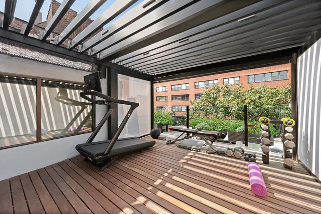 a living room with furniture tv and large windows