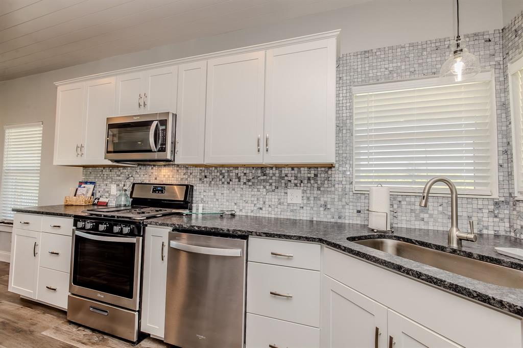 1525 McAdams Road, Unit C Graford, TX 76449 - Photo 10 of 38 Stainless steel appliance package with natural gas stove.