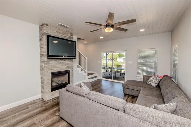 a living room with furniture and a large window with wooden floor