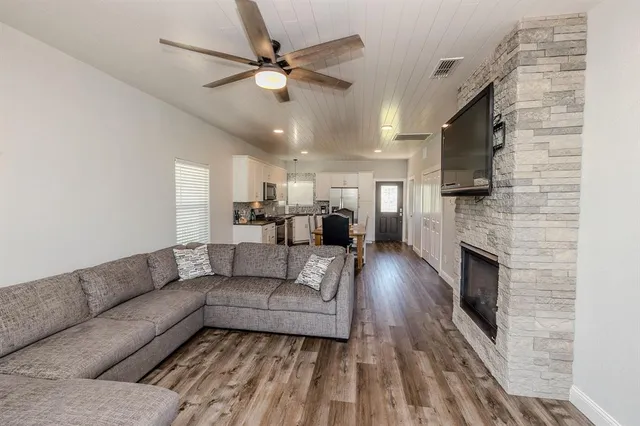 a living room with furniture a fireplace and a flat screen tv