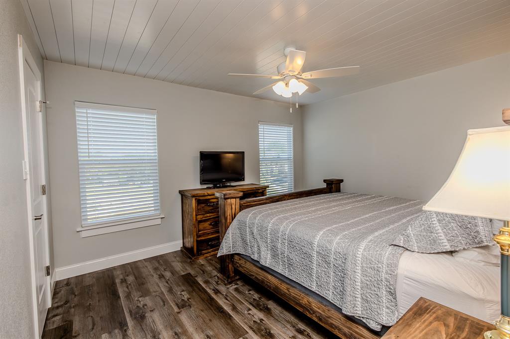 1525 McAdams Road, Unit C Graford, TX 76449 - Photo 21 of 38 This upstairs bedroom features a view of the lake.