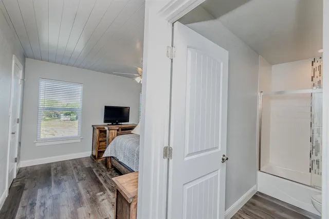 a bedroom with a bed and a flat screen tv