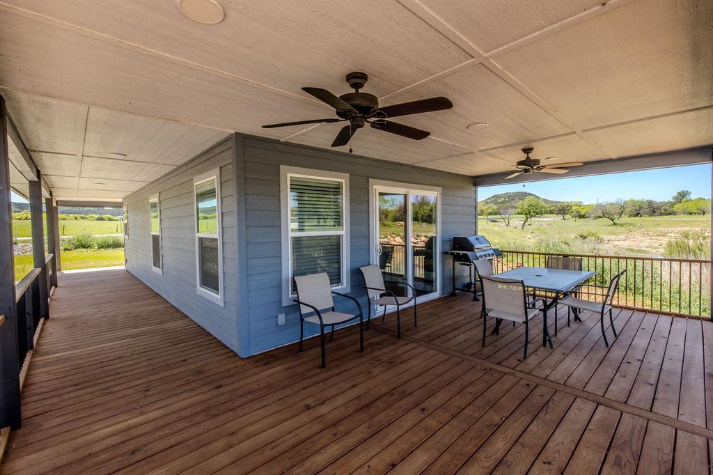 1525 McAdams Road, Unit C Graford, TX 76449 - Photo 27 of 38 Covered deck on three sides of the cabin for plenty of outdoor enjoyment space.