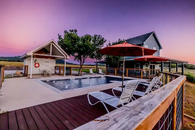 a view of house with swimming pool outdoor seating