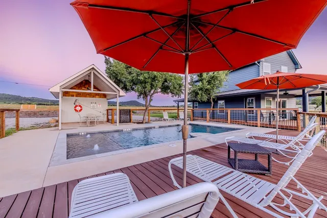 a view of a swimming pool with lawn chairs