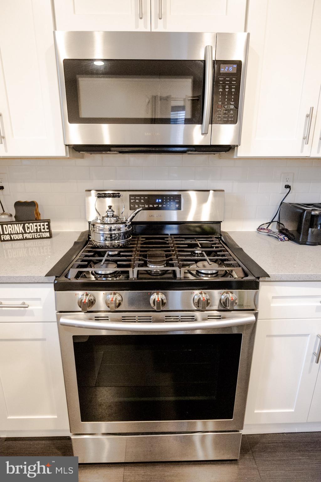 6113 Ross Street Philadelphia, PA 19144 - Photo 18 of 40 a stove top oven sitting inside of a kitchen