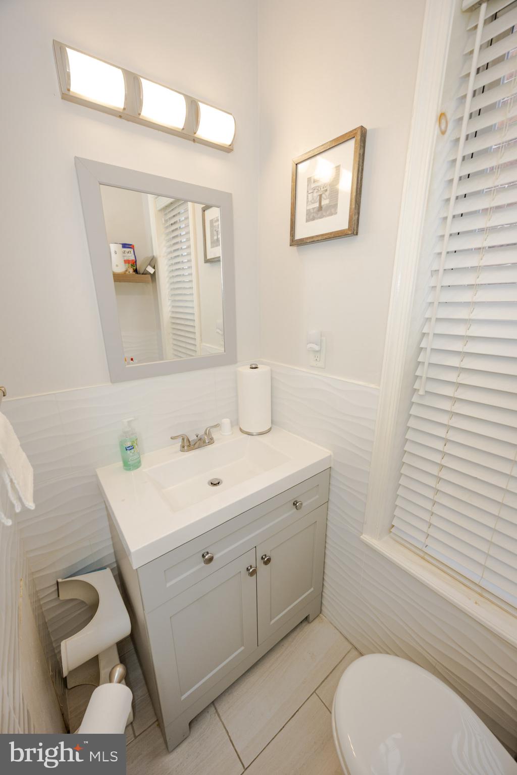 6113 Ross Street Philadelphia, PA 19144 - Photo 25 of 40 a bathroom with a sink a toilet and mirror