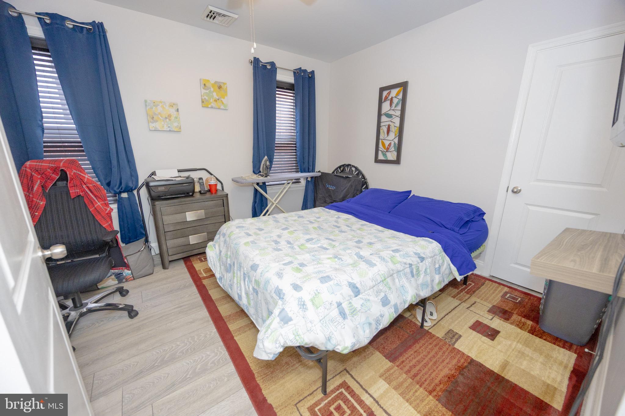 6113 Ross Street Philadelphia, PA 19144 - Photo 28 of 40 a bedroom with a bed and wooden floor