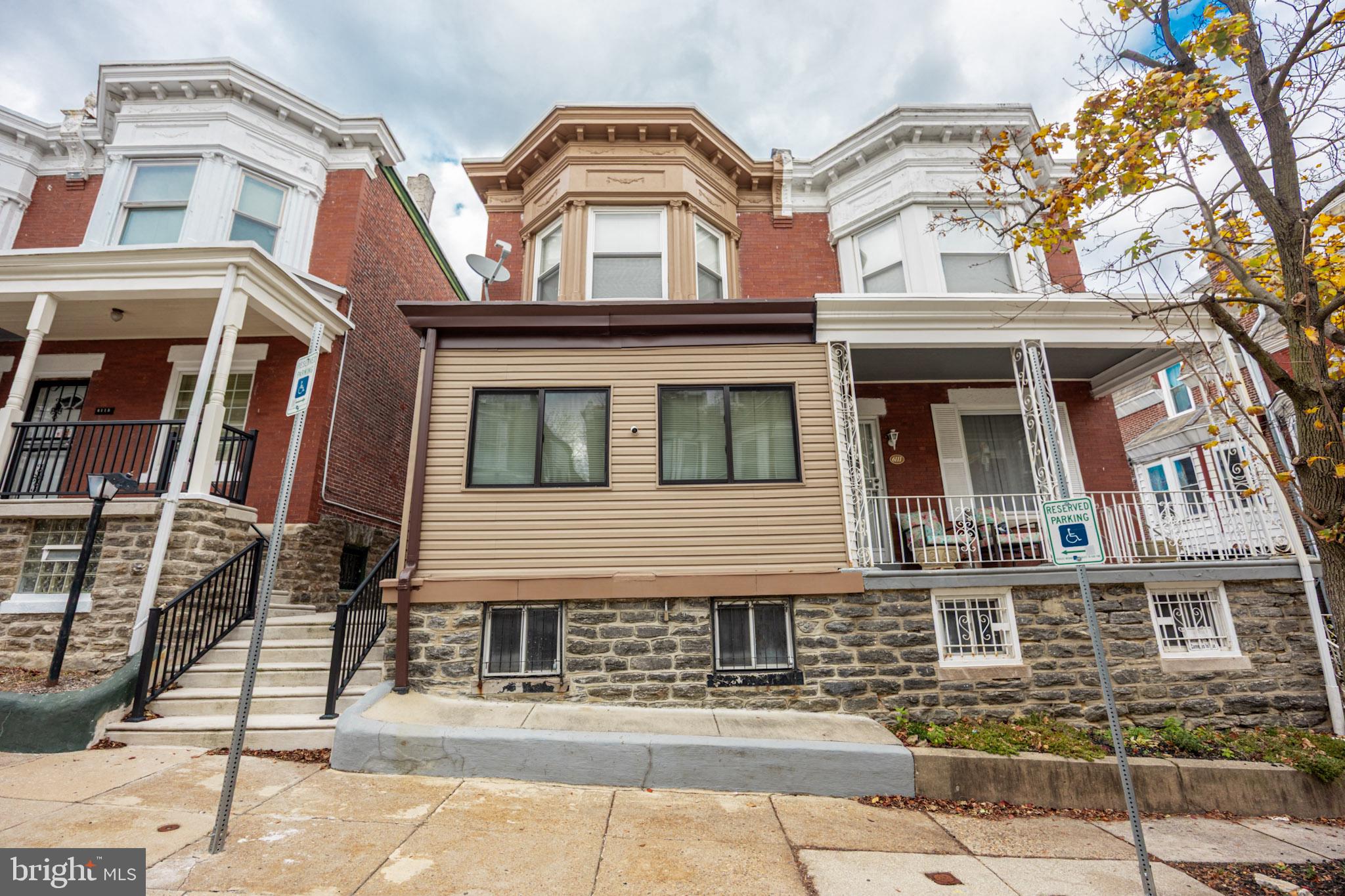 6113 Ross Street Philadelphia, PA 19144 - Photo 3 of 40 a front view of a residential apartment building with a yard