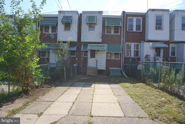 a view of a brick building next to a yard