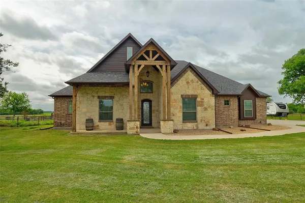 a front view of a house with garden