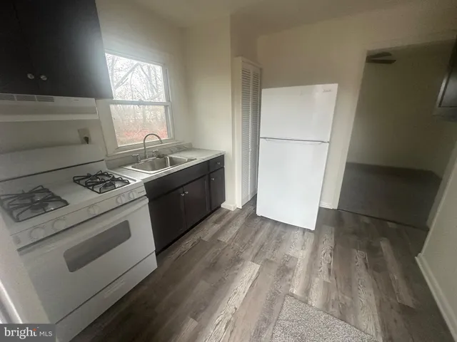 a kitchen with a stove sink and refrigerator