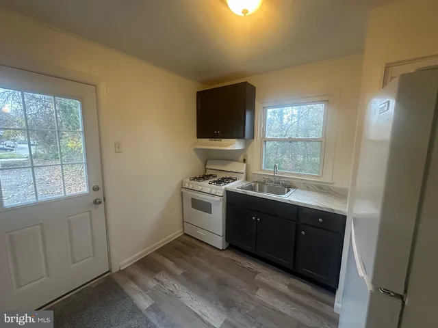 a kitchen with a sink and a stove top oven