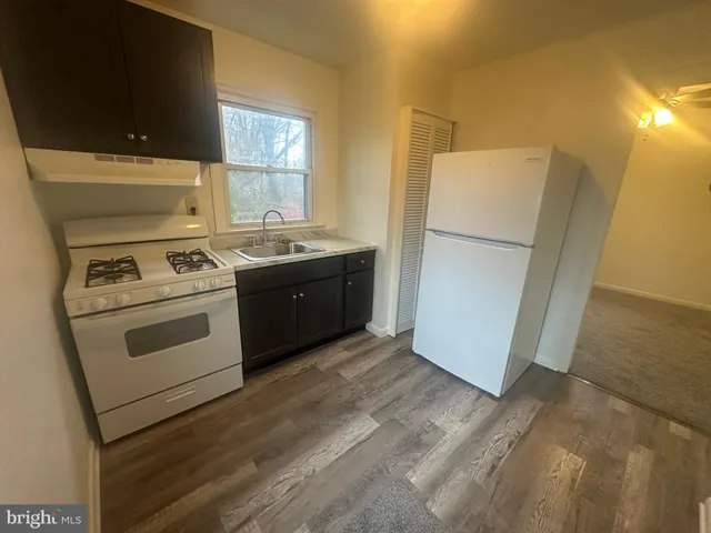 a kitchen with a stove and a refrigerator