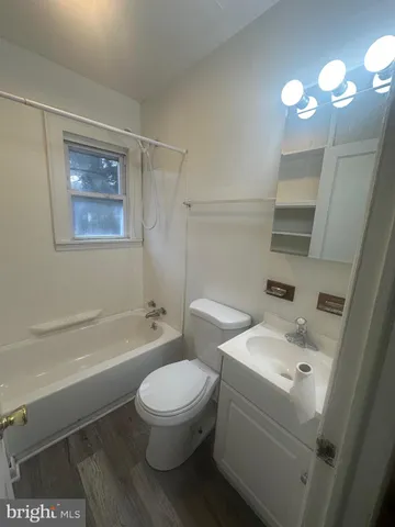a white toilet sitting next to a bathroom sink and tub