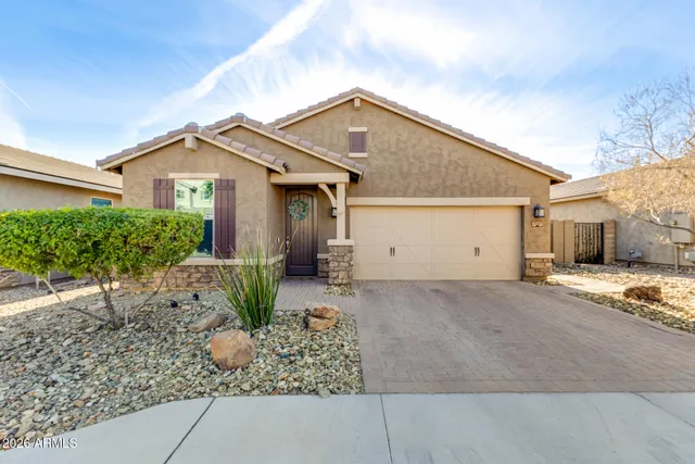 a view of a house with a yard and plants