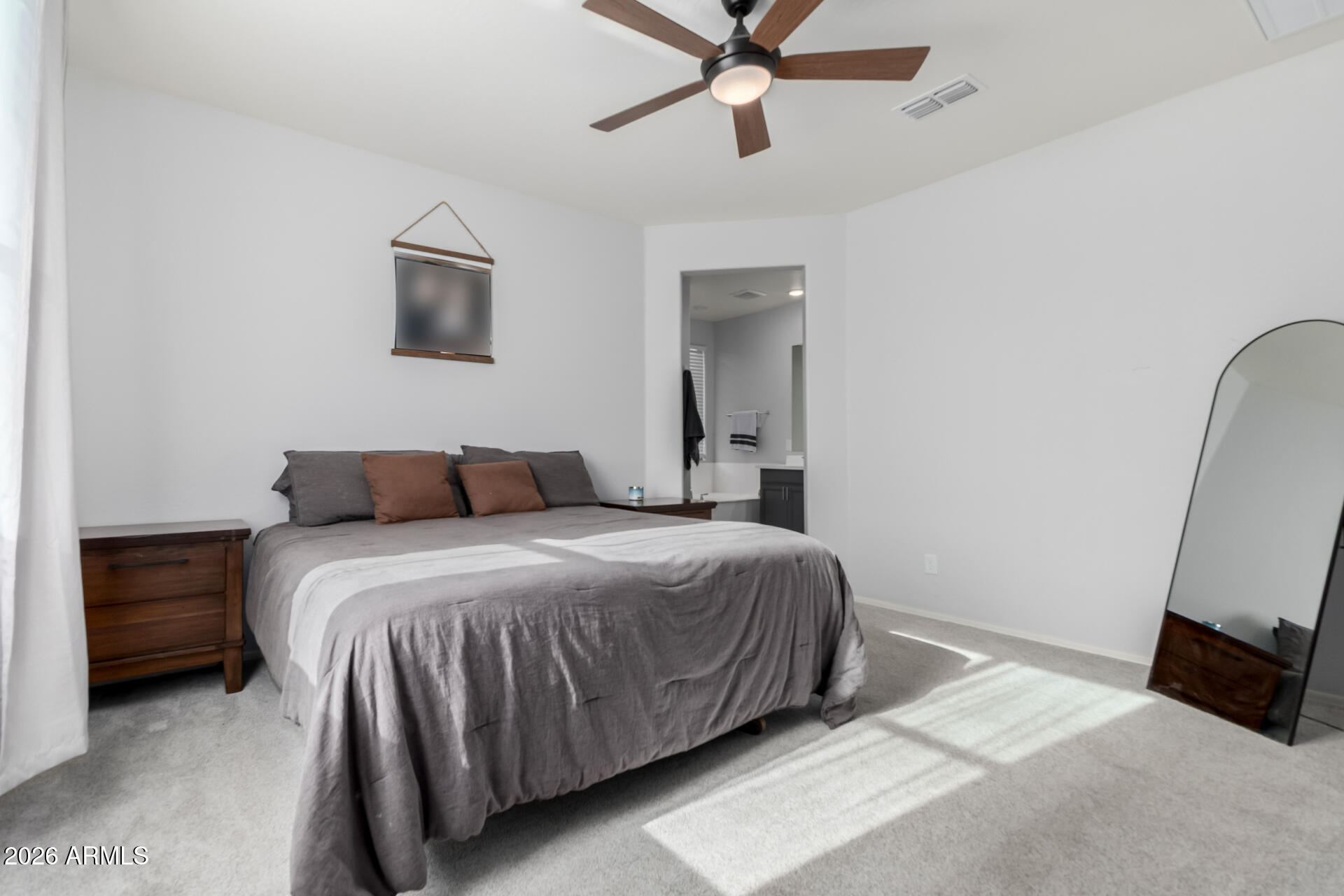 2929 West Laredo Lane Phoenix, AZ 85085 - Photo 12 of 28 a bedroom with a bed and a flat tv screen on dresser