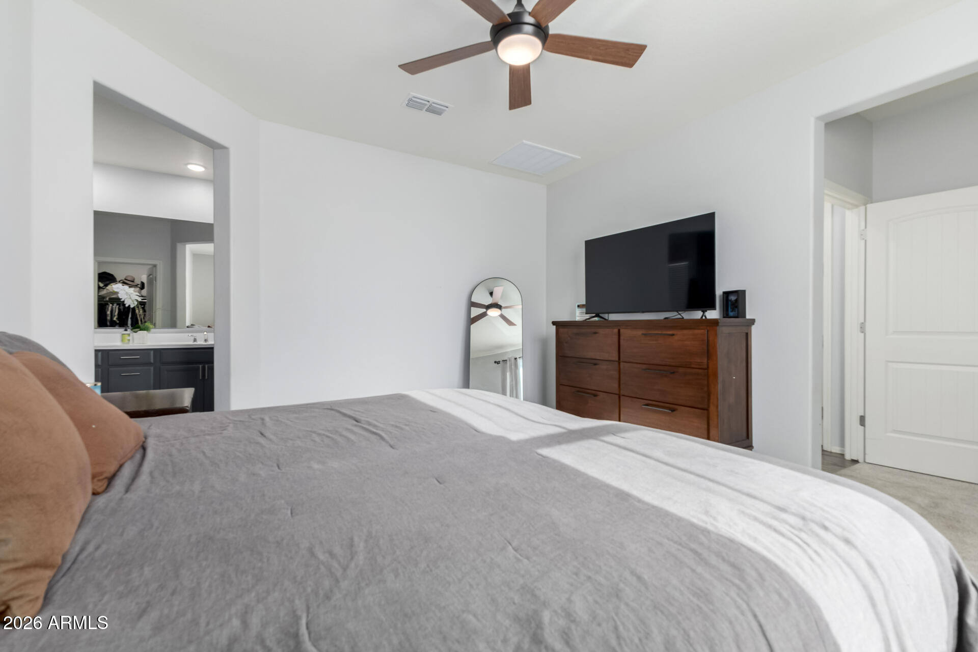 2929 West Laredo Lane Phoenix, AZ 85085 - Photo 13 of 28 a bedroom with a bed and a flat screen tv