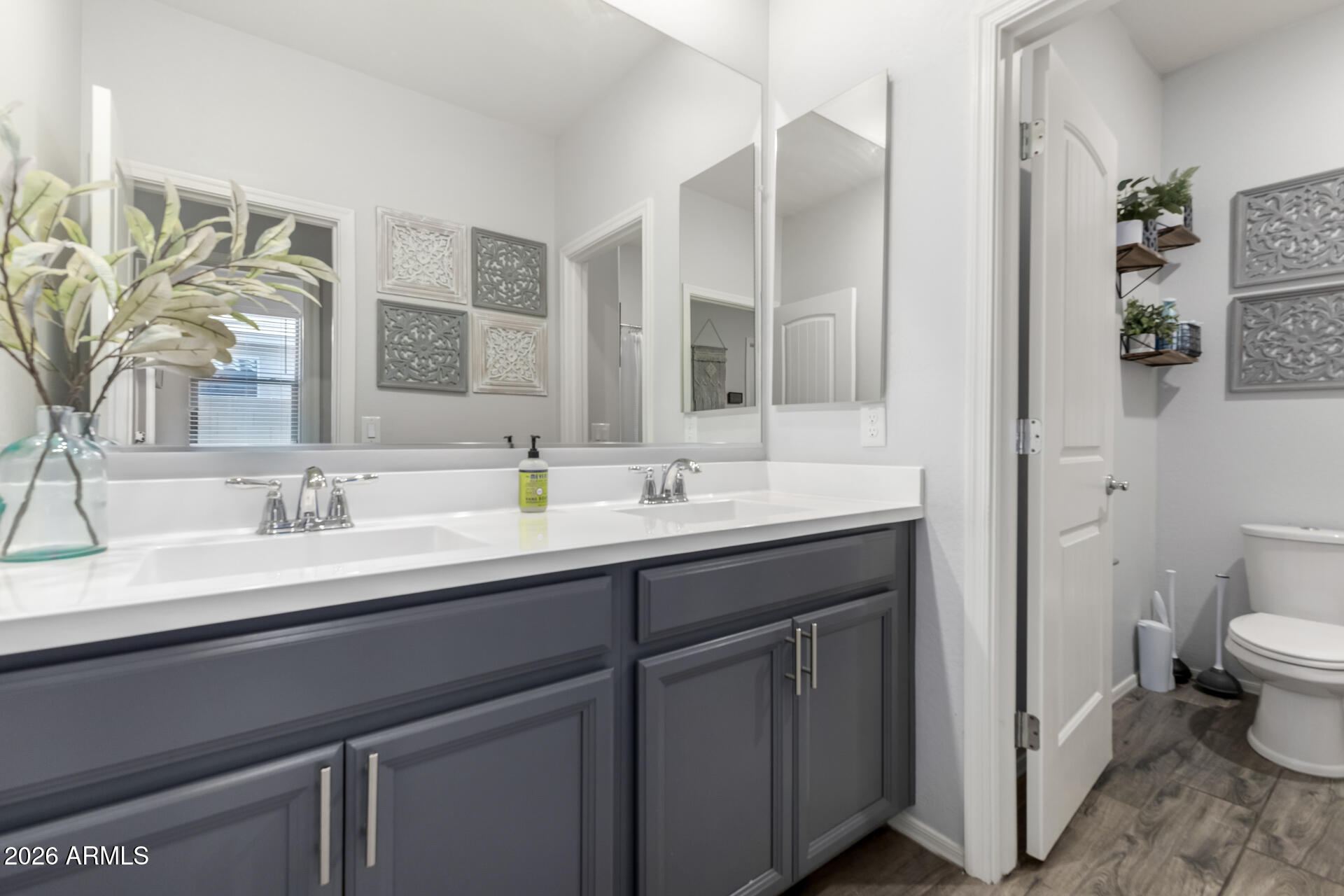 2929 West Laredo Lane Phoenix, AZ 85085 - Photo 21 of 28 a bathroom with a double vanity sink toilet and mirror