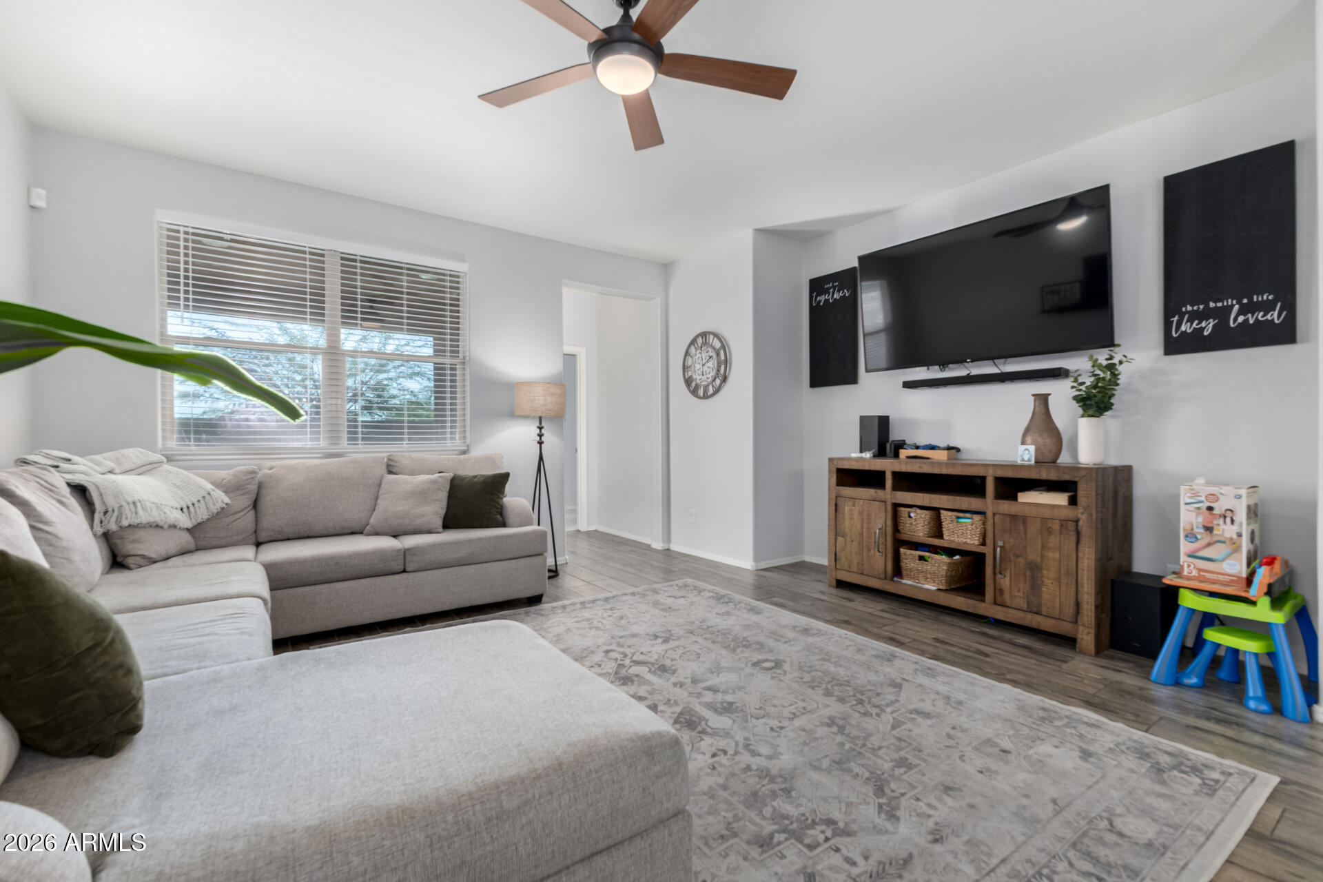 2929 West Laredo Lane Phoenix, AZ 85085 - Photo 7 of 28 a living room with furniture and a flat screen tv
