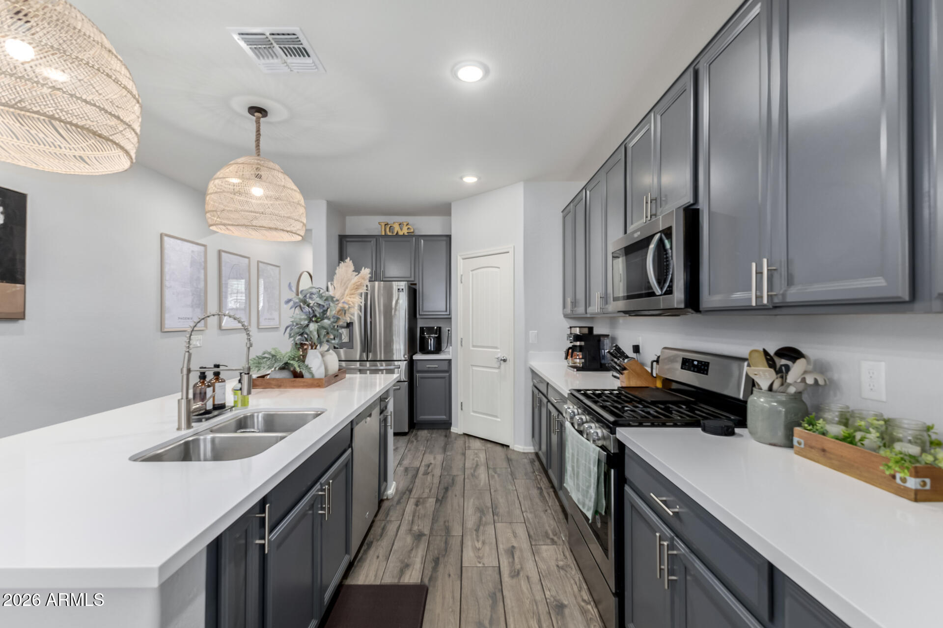 2929 West Laredo Lane Phoenix, AZ 85085 - Photo 9 of 28 a kitchen with a sink stove and microwave