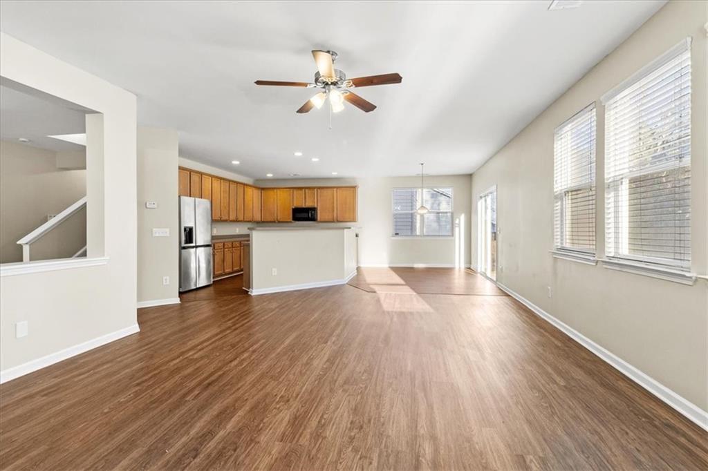 125 Parkmont Court Dallas, GA 30132 - Photo 13 of 36 a view of a big room with wooden floor a kitchen view and windows