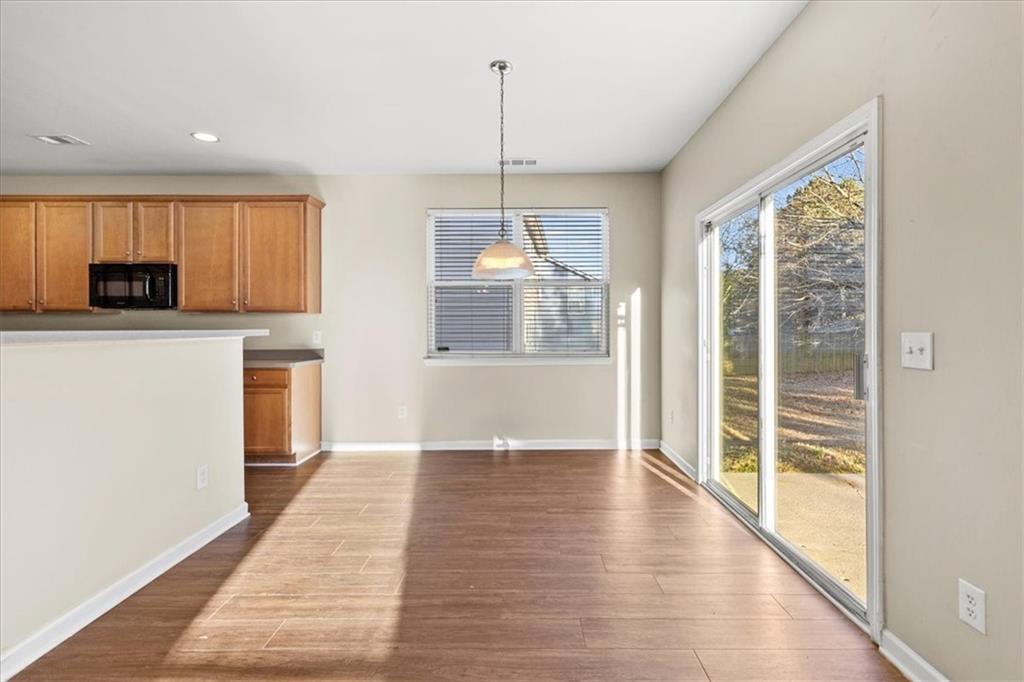 125 Parkmont Court Dallas, GA 30132 - Photo 14 of 36 a view of a kitchen with wooden floor and a window